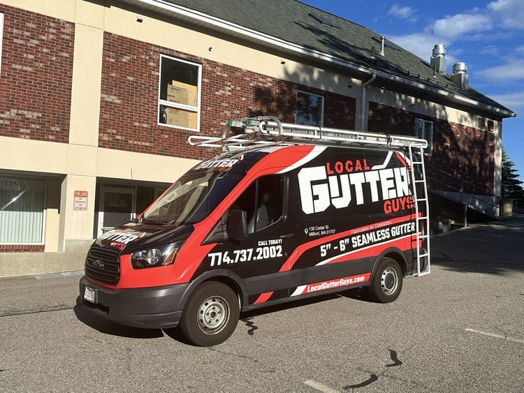 Local Gutter Guys crew installing seamless gutters